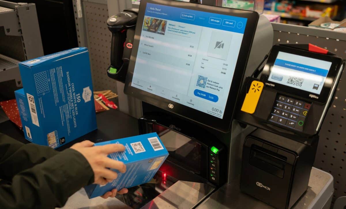 A shopper scans a product barcode on its packaging at a self-checkout lane inside a Walmart Supercenter in Tigard, Oregon.