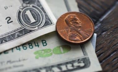 Close-up of U.S. dollar bills and a penny
