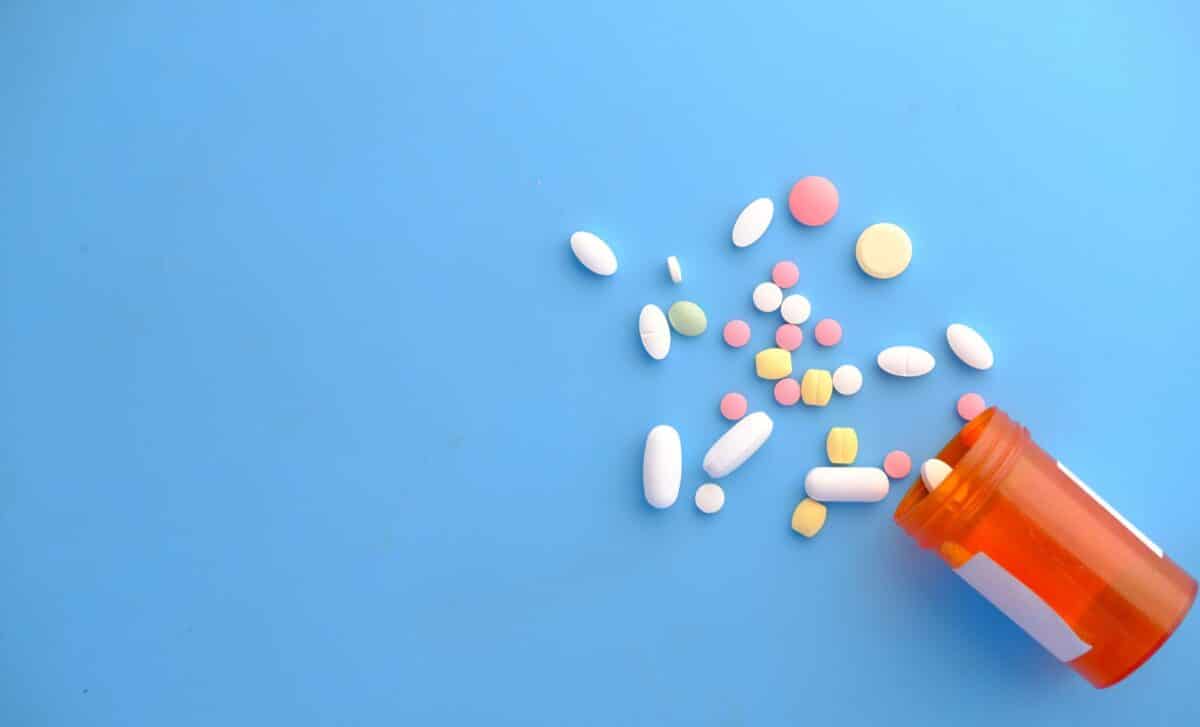 Spilled pills on a blue background