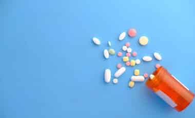 Spilled pills on a blue background
