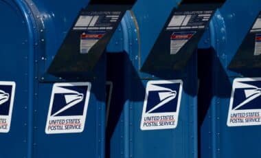 Three USPS mailboxes at curbside