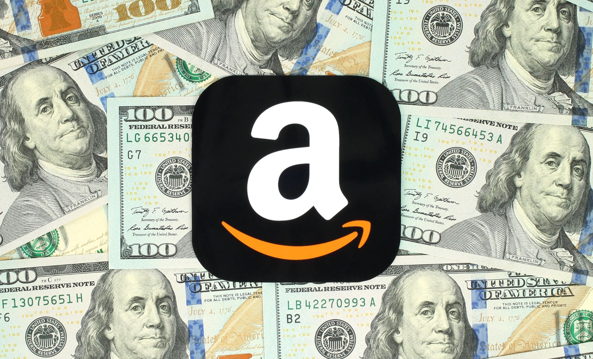 Amazon icon printed on paper and placed on money background.