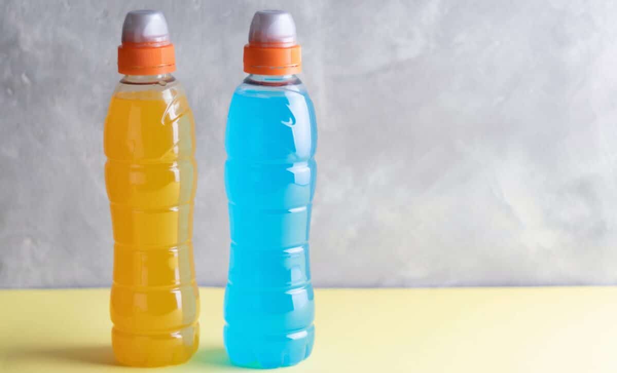 Blue and yellow isotonic drinks with copyspace