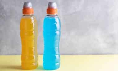 Blue and yellow isotonic drinks with copyspace